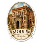 Pamiątkowy magnes Modlin Twierdza z motywem zabytkowej architektury z czerwonej cegły, otoczonej zielenią