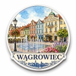 Pamiątkowy magnes Wągrowiec przedstawiający ulicę z fontanną, kwiatami i budynkami w stylu historycznym